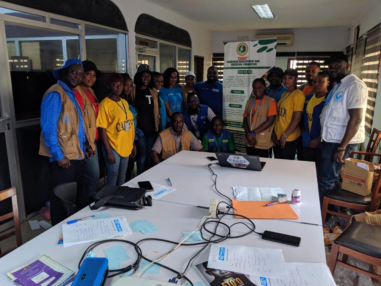 CADEF and INTERSOS team members gathered around the office meeting table
